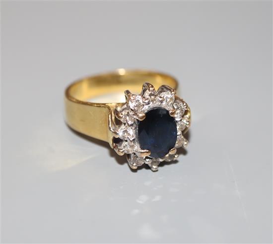 A modern 18ct gold, sapphire and diamond oval cluster ring, size M, gross 6.7 grams.